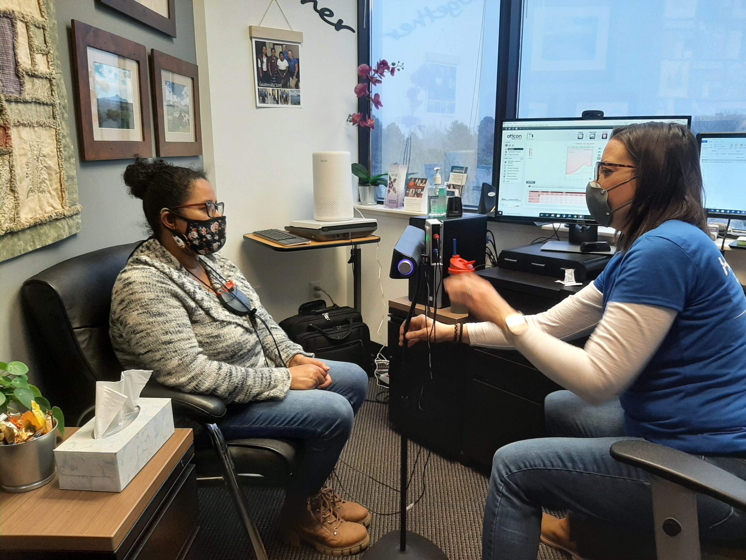 Brenda Garcia, hearing instrument specialist at Columbine Hearing Care in Littleton, Colorado, helping a patient