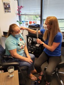 Dr. Dusty helps her patient to choose the best hearing aid.