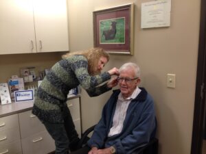 Dr. Dusty works with a hearing loss patient