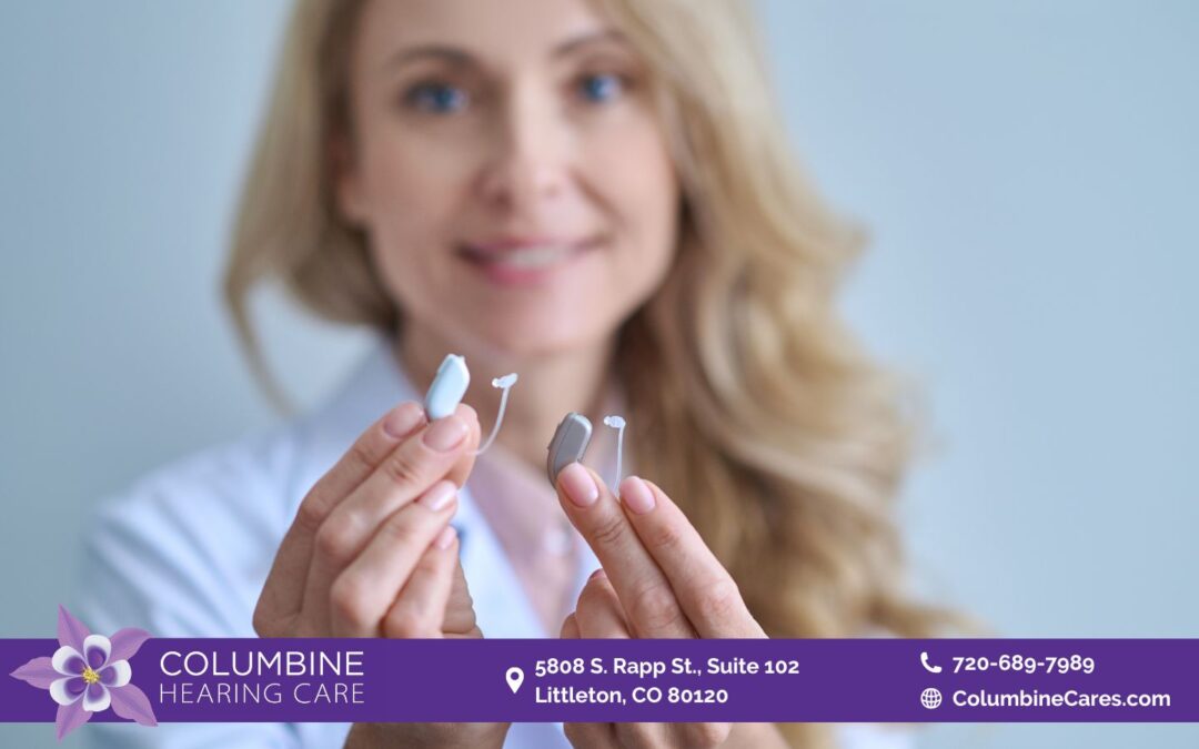 an image of a zoomed in hearing aid being help by a woman out of focused